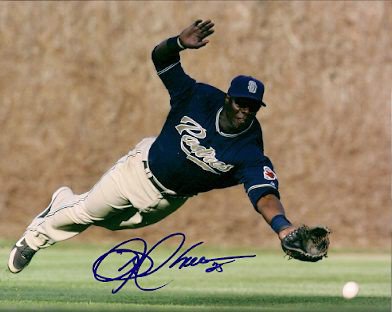 San Diego Padres center fielder Mike Cameron autographs a young